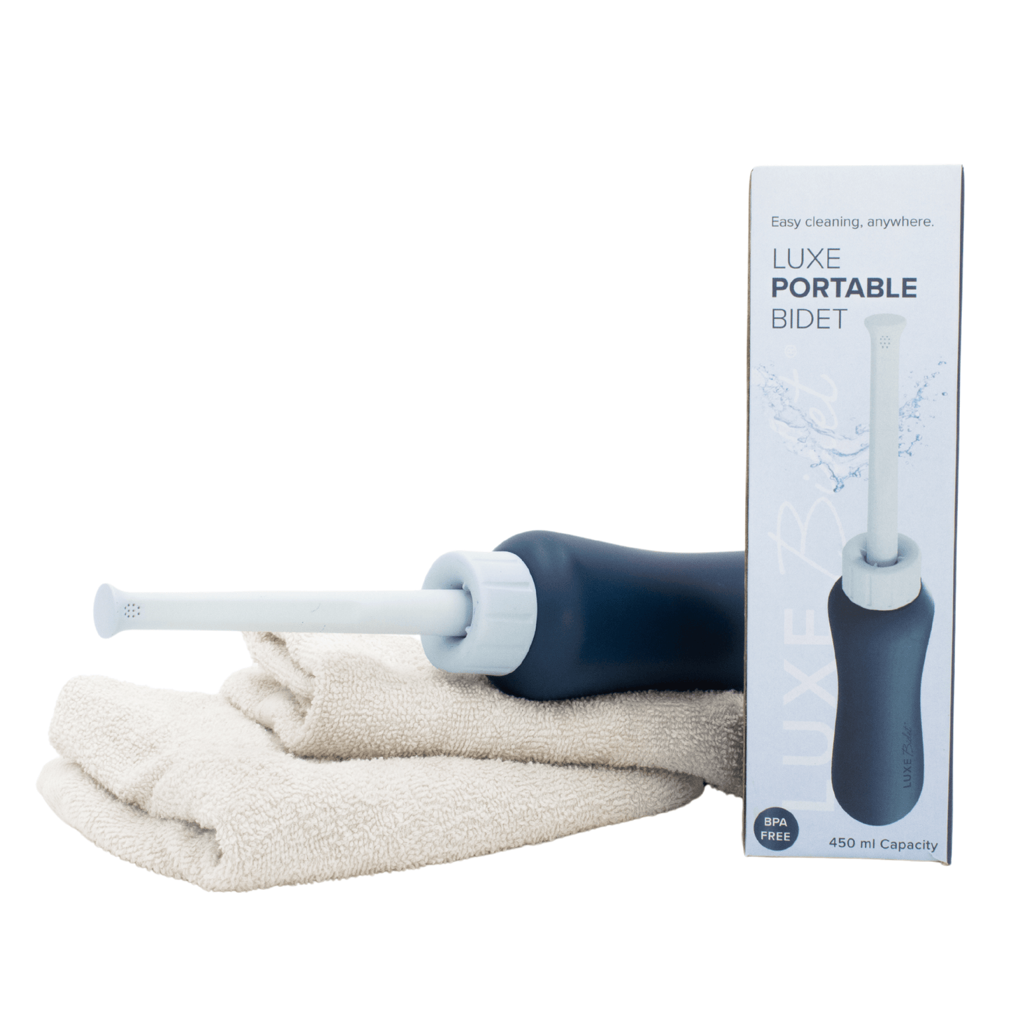 LUXE Portable Bidet rest on towels with its packaging. *Towels not included.