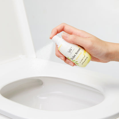 Hand spraying Lemon Peel Whift into the toilet