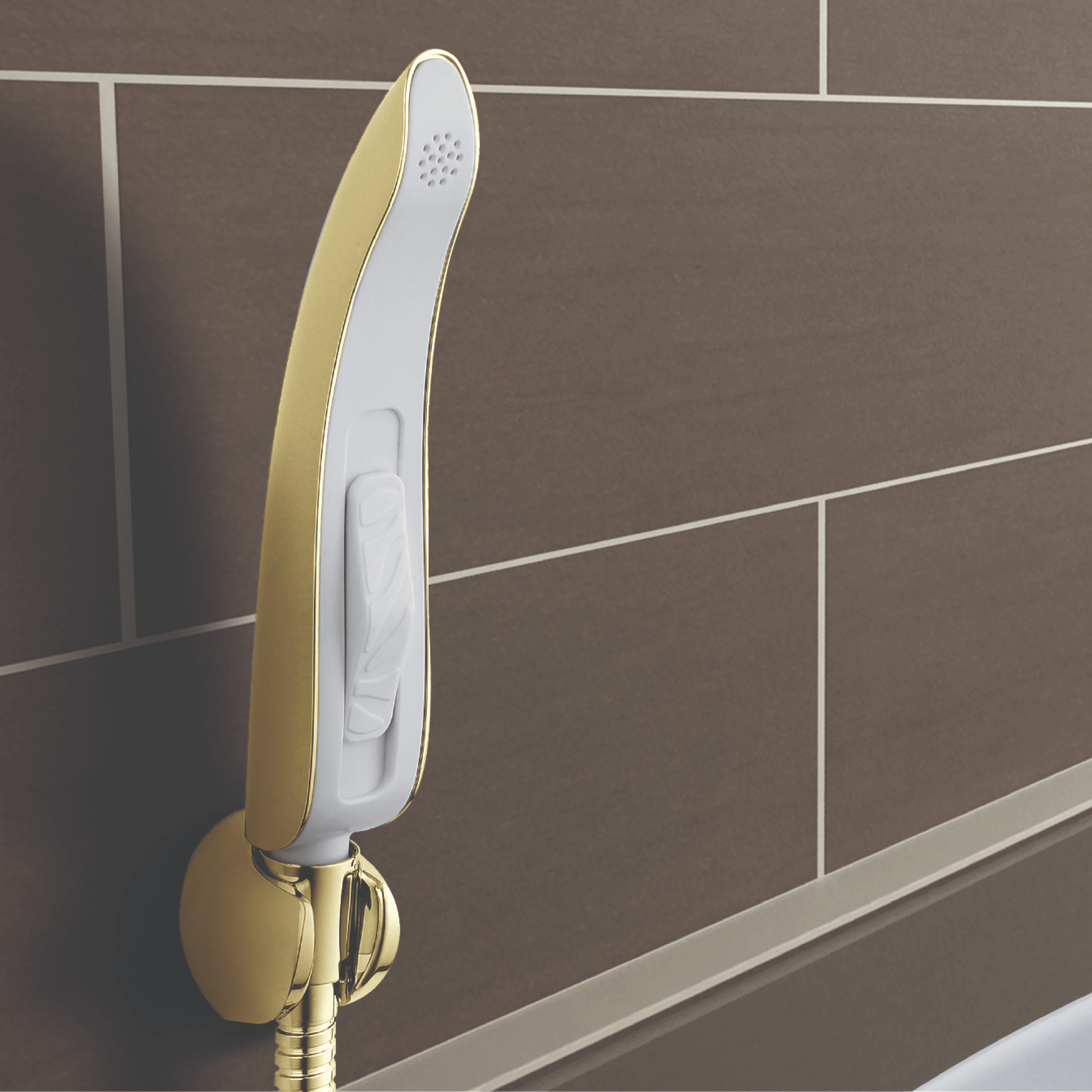 Handheld Bidet NEO 70 (Gold) mounted on a brown bathroom wall