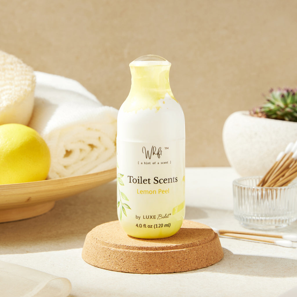 Whift Toilet Scents Spray - 120 mL Lemon Peel Whift Toilet Scents Spray on a cork coaster with lemons and Q tips