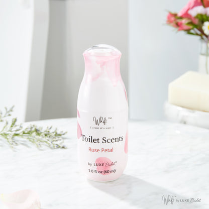 60 mL Rose Petal Whift Toilet Scents Spray on marble with a blurred background of flowers