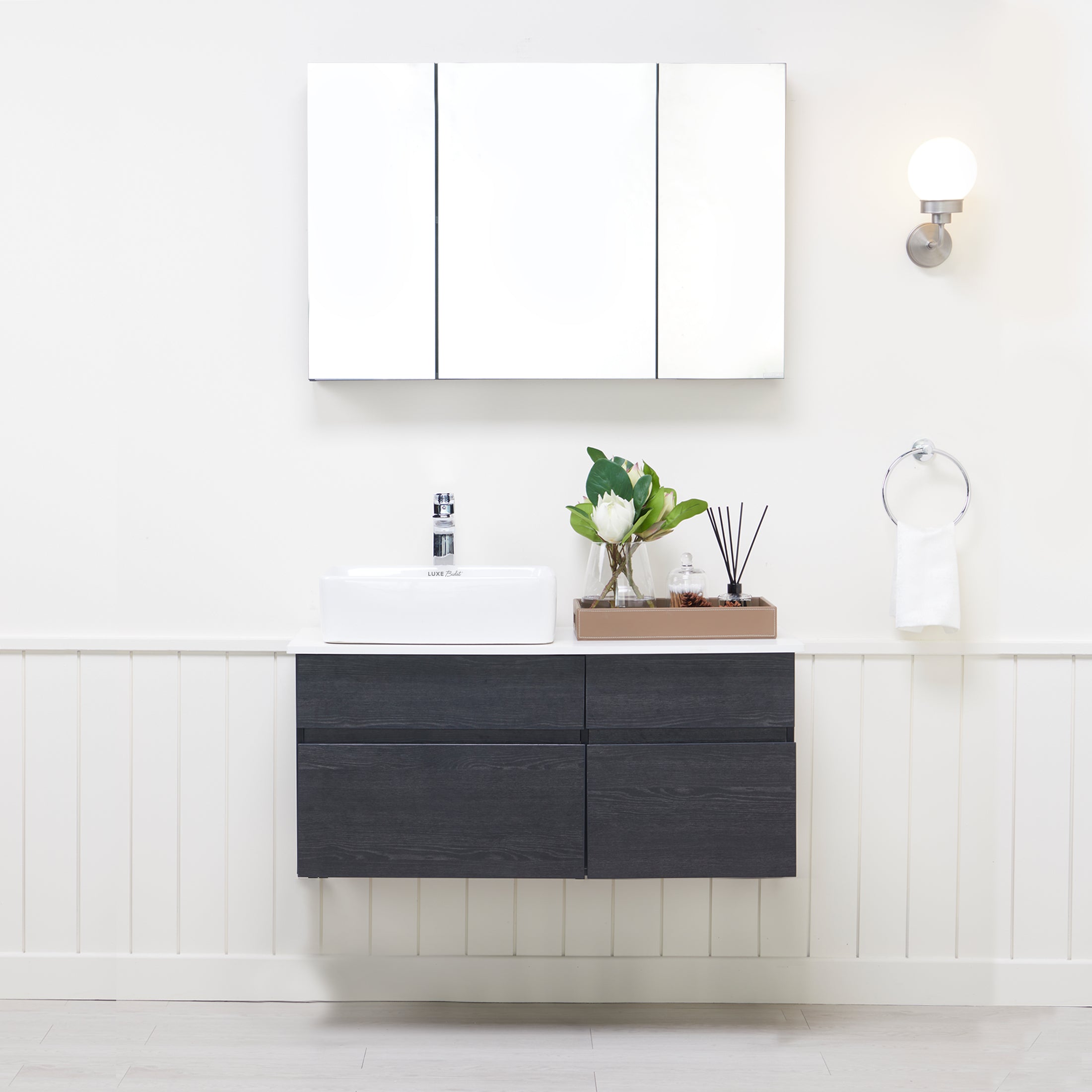 Sophea Bathroom Vanity Set, front-facing with bathroom décor & toiletries on counter and in cabinets