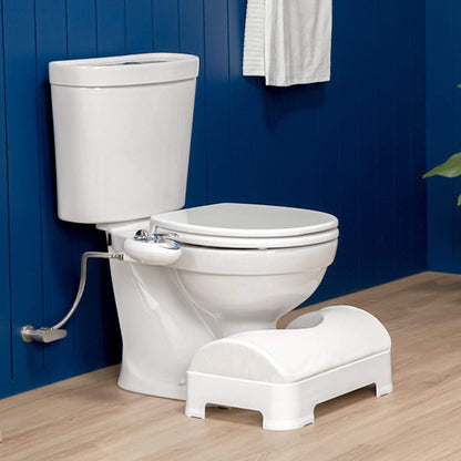 LUXE Comfort Soft & Ergonomic Toilet Footstool tucked into a toilet, side angle, modern blue wooden bathroom with brown floor