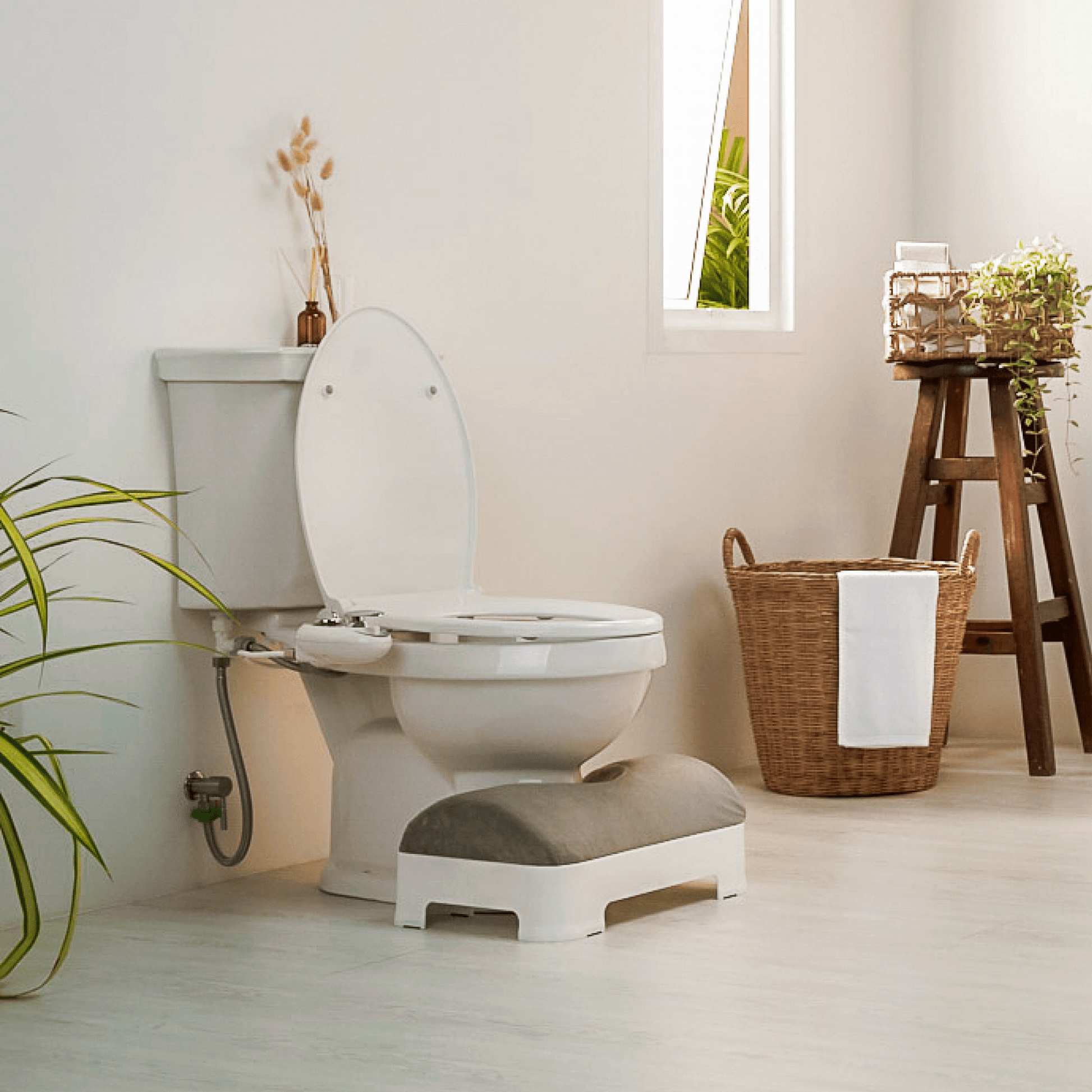 LUXE Footstool: Velour Covers - Gray - Footstool is tucked into toilet in a modern bathroom