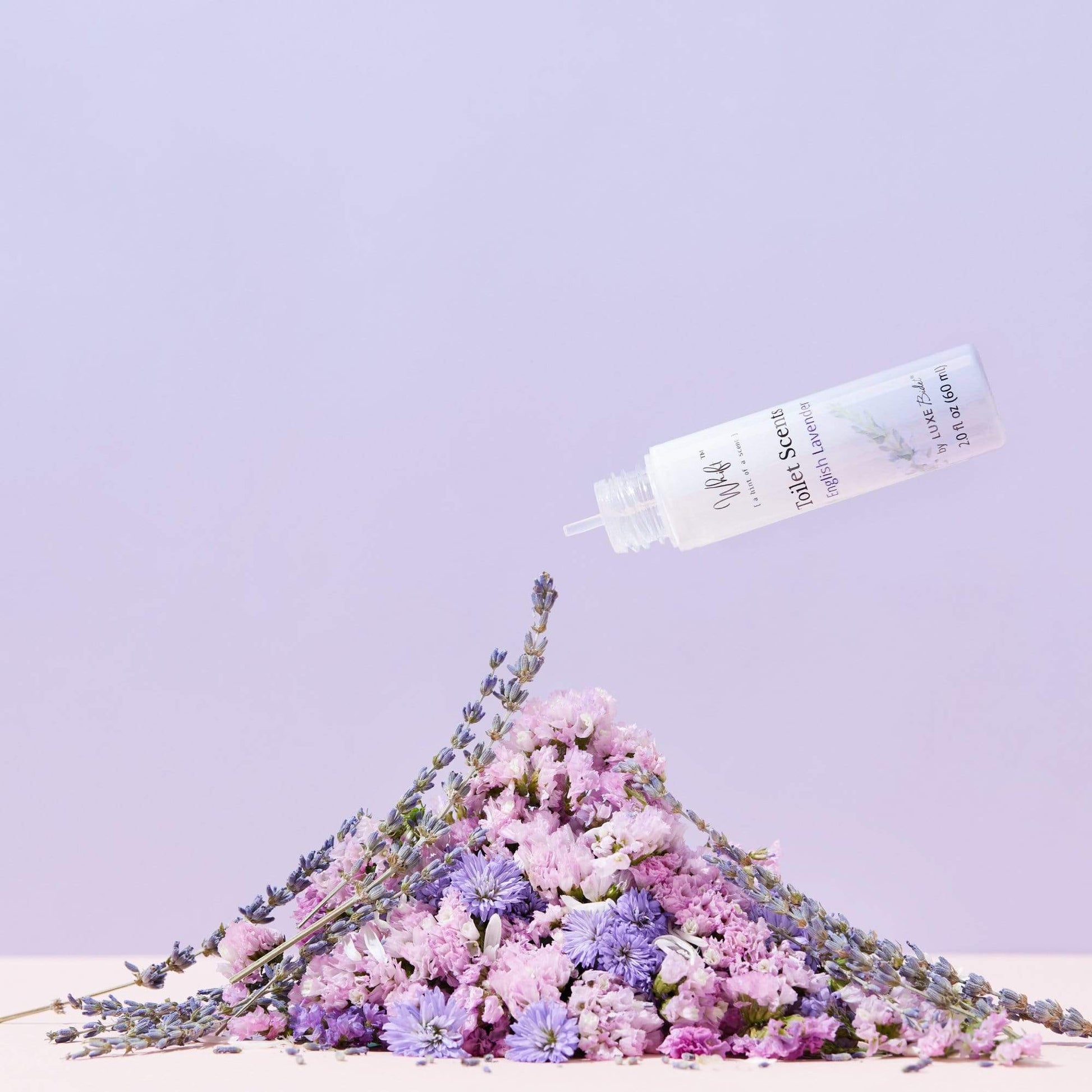 60 mL English Lavender Whift Toilet Scents Drops being squeezed over a pile of flowers