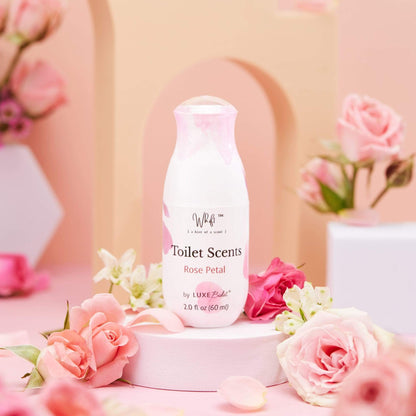 60 mL Rose Petal Whift Toilet Scents Spray on platform with blurred background of flowers